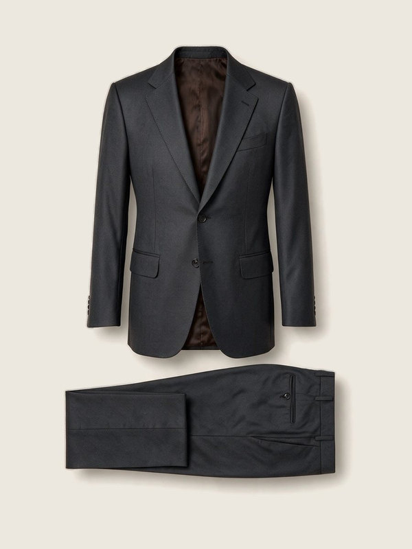 A charcoal suit laid flat: the jacket above, the trousers folded below.